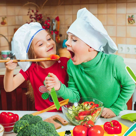 Montessori kids knife set with wooden toddler knives and green handles, kids cooking with vegetables.
