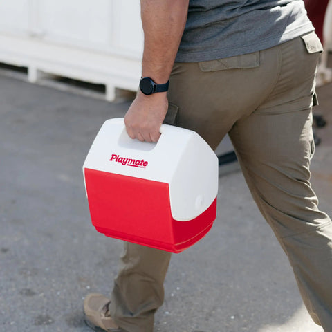 Man carrying Playmate Portable Cooler With Tent Top Design, Push Button One Hand Lid Operation, Left Or Right Swing Lid For Easy Access, Red