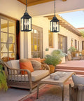Badass Matte Black Outdoor Pendant Lighting Three Bulb Exterior Hanging Porch Fixture With Clear Glass Shades in a cozy patio setting.