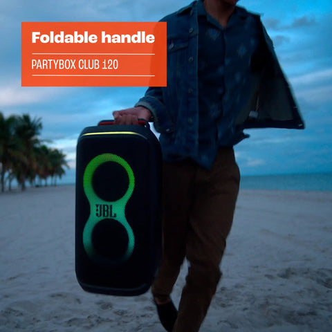 Person carrying Portable Party Speaker With Foldable Handle And Pro Sound, Club 120 Delivers Dope Bass on beach at dusk