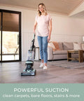 Lightweight Bagless Upright Vacuum With Massive Dust Cup And Smooth Swivel Steering used by a woman on tiled floor.