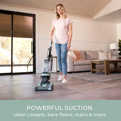 Lightweight Bagless Upright Vacuum With Massive Dust Cup And Smooth Swivel Steering used by a woman on tiled floor.