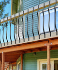 Straight Up Heavy Duty Cast Iron Curve Deck Balusters With Screws 29.5 Inch Wave Arc Metal Spindles Rust Resistant black spindles on outdoor porch railing.