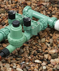All In One Drip Irrigation System With Filter And 30 PSI Regulator And Drip Lock Adapter in garden setup on gravel