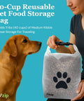 Large Roll Top Pet Food Storage Bag With Airtight Seal Keeps Kibble Fresh 40 Cup Capacity BPA Free shown held by person with dog.