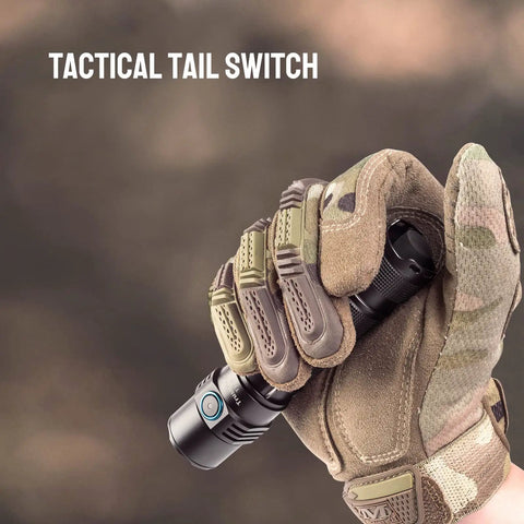 Gloved hand holding Ultra Bright 1800 Lumen LED Tactical Flashlight with tactical tail switch, outdoor background