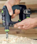 Kickass Cordless Drill Driver Pack Featuring Knockout Torque And Boss Level Brushless Motor With No Sweat Ergonomic Grip And Quick Swap Battery System For Serious Woodworking And Auto Repairs in use on wood shavings.