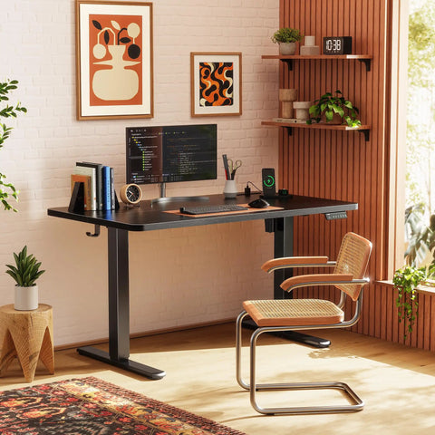 Modern home office with Electric Standing Desk 47 By 24 Inch With Built In Power Outlets And USB C Port, plants, and art.