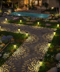 Six Pack Solar Outdoor Garden Lights With Mandala Pattern illuminating a garden pathway with warm amber glow, quick install, night view