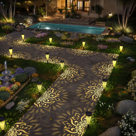 Six Pack Solar Outdoor Garden Lights With Mandala Pattern illuminating a garden pathway with warm amber glow, quick install, night view