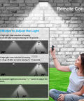 Woman using remote for Outdoor Solar Lights With Remote Control 180 Degree Adjustable 56LED Flood Lights Motion Sensor Security