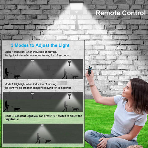 Woman using remote for Outdoor Solar Lights With Remote Control 180 Degree Adjustable 56LED Flood Lights Motion Sensor Security
