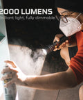 Person using SLYDE KING 2K Rechargeable LED Flashlight With 4X Zoom Spotlight Or Floodlight for enhanced brightness while painting.