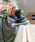 Man using electric sander with Granat Profile Soft 6 Inch Sanding Discs 10 Pack For Contours Curves And Moldings With Flexible Foam Backing