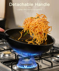 Cooking spaghetti in a 21 Piece Nonstick Ceramic Pots And Pans Set With Detachable Handles, RV Ready Kitchen Gear For Easy Storage, Oven Safe And Induction Ready, Stackable Black Cookware, The Ultimate Father's Day Gift For Men on stove.
