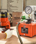 Beefy 10,000 PSI 750W 110V Electric Hydraulic Pump Power Pack with 8 L capacity and dual 9.8 ft oil lines, orange unit in use