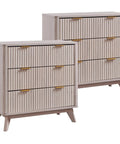 Set Of Two Fluted Nightstands Featuring Three Spacious Drawers And Clean White Alder Finish in light wood with gold handles.
