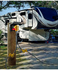 RV Power Adapter Cord 50A Male To Dual 30A Female, 2.5 Ft Handy Grip Handle connected to RV at campground hookup.