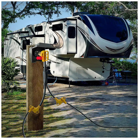 RV Power Adapter Cord 50A Male To Dual 30A Female, 2.5 Ft Handy Grip Handle connected to RV at campground hookup.