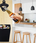 Heavy Duty Cast Iron Bottle Cap Opener Wall Mounted With Catcher Tray For Garage Bar Or Home Man Cave Built Tough As Nails And Crafted For Easy Weekend Party Hosting in a kitchen setting.