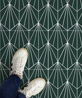 Person wearing white sneakers standing on Beryl Peel And Stick Floor Tiles Emerald Green Geometric Vinyl For Easy DIY Install