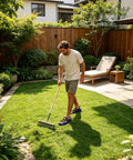 Man walking in a garden wearing Lawn Aerator Shoes With Heavy Duty Adjustable Spiked Soles For Yard And Garden Aeration, Root Health Boost.