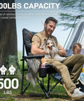 Oversized Padded Folding Camping Chair For Adults, Heavy Duty Portable Quad Chair, supports 500 lbs, man with dog outdoors