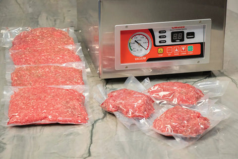 Chamber Vacuum Sealer CM255 for home and commercial kitchens with vacuum-sealed meat packs on countertop