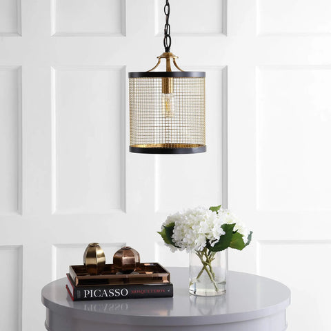 10-Inch Black And Brass Gold 1-Light Iron Pendant Lantern hanging over a table with flowers and books, modern drum design