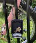 Rugged Outdoor Key Lock Box With Cable Shackle, Small Waterproof Metal Safe, 4 Digit Combo on bike rack with keys inside, open