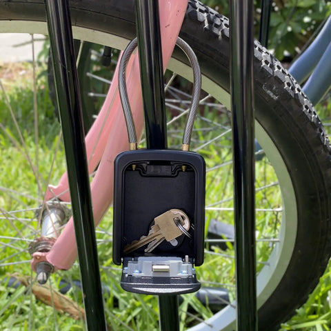 Rugged Outdoor Key Lock Box With Cable Shackle, Small Waterproof Metal Safe, 4 Digit Combo on bike rack with keys inside, open
