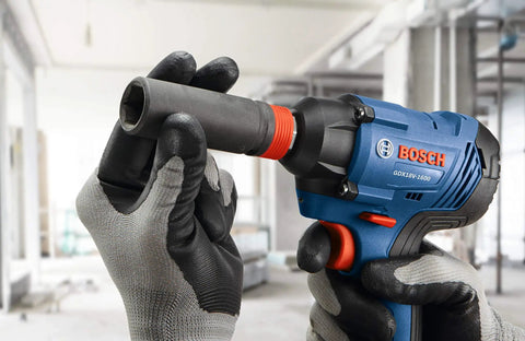 Gloved hands using Two-In-One 18V Impact Driver Kit With 1/4 Inch Quick-Change Hex And 1/2 Inch Drive, Delivers Up To 1,600 In-Lbs Torque