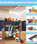 Heavy Duty Sports Equipment Garage Organizer With Ball Storage Rack Basket Hooks And Rolling Cart For Sports Gear And Toy Storage Indoor Outdoor Use Black in a gym with balls and bats.
