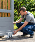 Man installing Heavy Duty 4 Pack Vertical Track Roller Wheels For Garden Gate Replacement With Non Slip Rubber Tires.