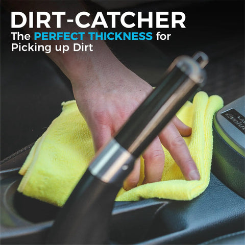 Person using yellow microfiber towel to clean car gear shift area