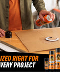 Person using Heavy Duty Spray Adhesive Clear Glue 14 Oz All Purpose Bond For Glass Plastic Wood Metal Ceramic Rubber Leather Paper