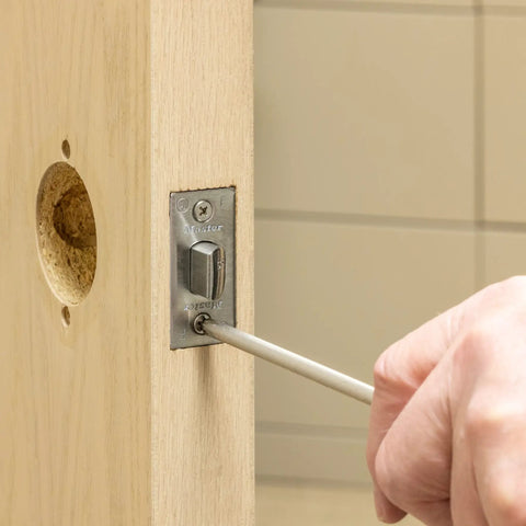Privacy Door Lock With Lever Handle For Commercial Interiors Brushed Chrome Finish being installed on wooden door