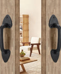 Heavy Duty Steel Barn Door Handles With Real Deal Rustic Matte Black Finish on sliding door in modern interior.