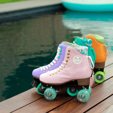 Pink and orange quad skates with Outdoor Roller Skate Wheels 38mm By 62mm 80A Turquoise 4 Pack Durable Urethane by poolside.