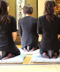 Three people kneeling using a Foldable Meditation Kneeling Bench Seiza Posture Support For Pain Free Kneeling, Ultra Portable And Lightweight, 5.3 Inch Seat, 180g, Black, Your Go To For Yoga And Meditation At Home Or On The Go