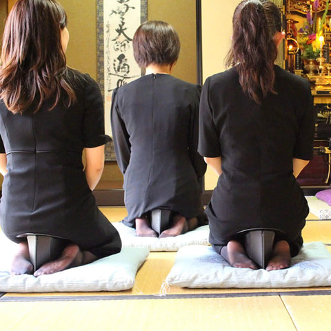 Three people kneeling using a Foldable Meditation Kneeling Bench Seiza Posture Support For Pain Free Kneeling, Ultra Portable And Lightweight, 5.3 Inch Seat, 180g, Black, Your Go To For Yoga And Meditation At Home Or On The Go