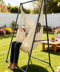 Person relaxing in All-In-One Hammock Chair Set With Foldable Stand And XL Swing Chair With Footrest For Indoor Outdoor Chill