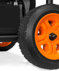 Close-up of Heavy Duty 4750 Watt Portable Generator With Electric Start and Wheel Kit showing durable orange wheel tread.