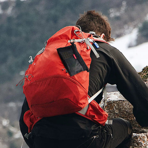 Black Grab-And-Go Water-Resistant Zipper Pouch Set Mesh Storage Bags attached to orange backpack on hiker