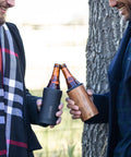 Two men cheers with bottles in Insulated Bottle Cooler For Standard 12oz Glass Bottles Keeps Beer And Soda Ice Cold On The Go Stainless Steel Drink Holder For Outdoor Travel And Adventures Portable Glass Bottle Cooler With Tight Seal