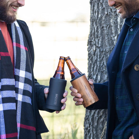Two men cheers with bottles in Insulated Bottle Cooler For Standard 12oz Glass Bottles Keeps Beer And Soda Ice Cold On The Go Stainless Steel Drink Holder For Outdoor Travel And Adventures Portable Glass Bottle Cooler With Tight Seal