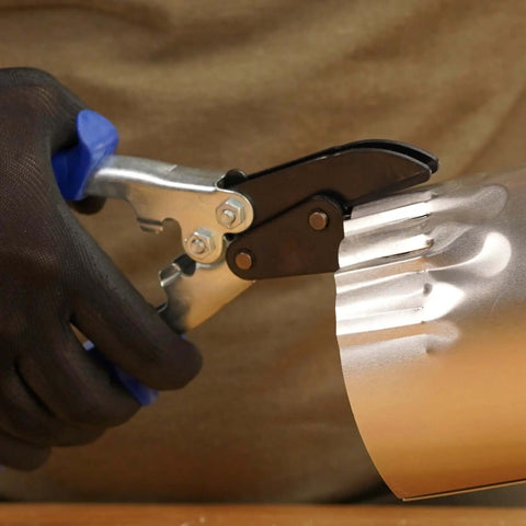 Person using 5-Blade Crimper For Straight And Wide Cut Pinch-Thru Point Cutter on metal pipe with hardened steel blades.
