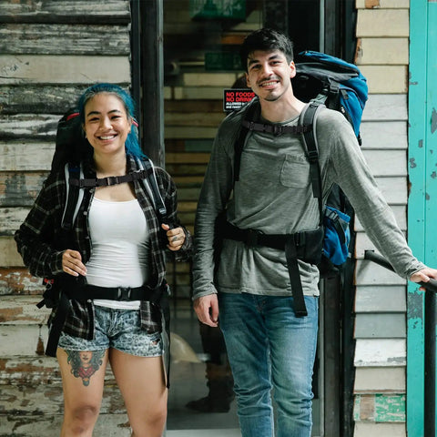 Two people wearing backpacks with Heavy Duty Backpack Chest Strap With Quick Release Buckle for hiking, black color