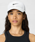 Model wearing Moisture-Wicking Dri-Fit ADV Club Structured Swoosh Cap With AeroBill Breathability For Dry Comfort All Day White Black Small Medium