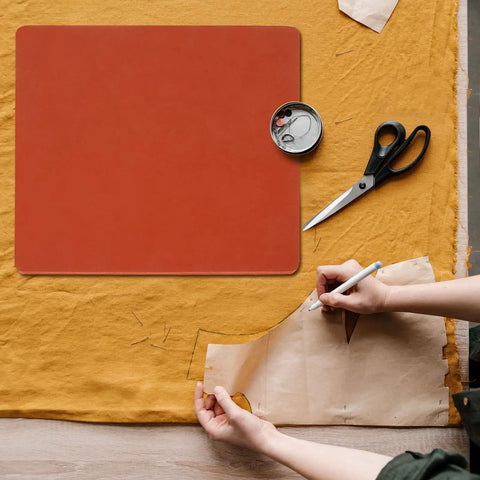 Premium 15x15 Inch Silicone Heat Press Pad Mat 0.3 Inch Thick Red beside scissors and sewing tools for precise heat transfers.